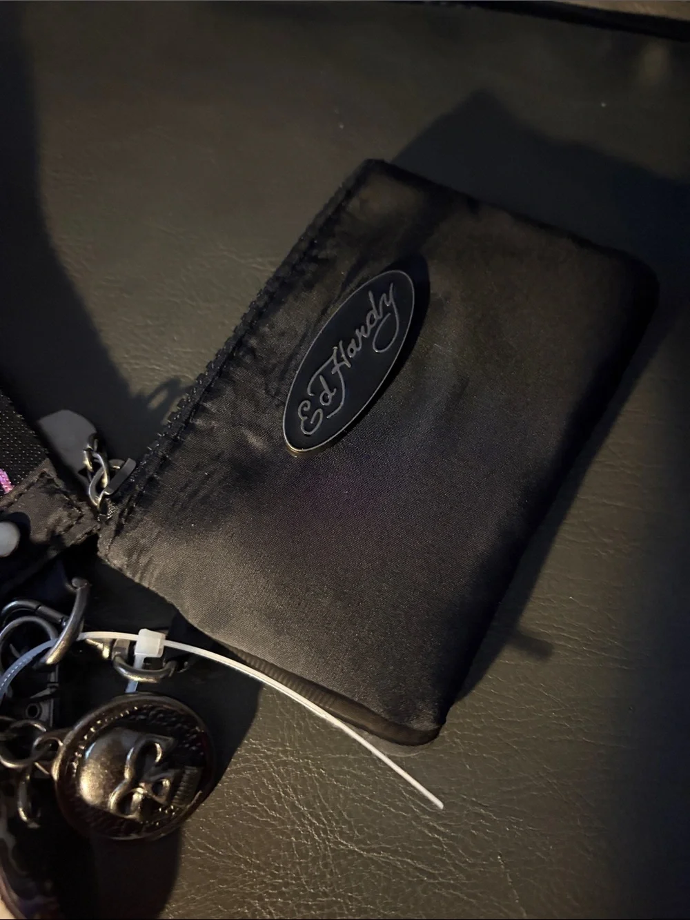Ed Hardy card pouch with leopard print and skull-and-rose motifs.